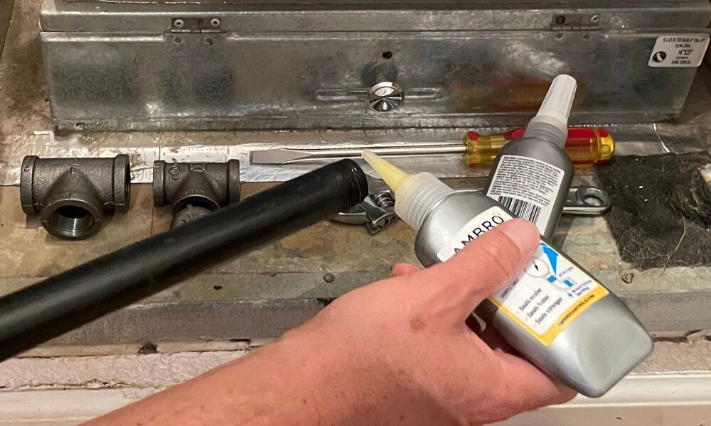 Technician applying the Ambro Controls AS-58 Thread Sealant on a pipe thread