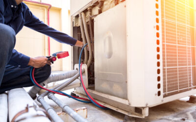 Technician is checking air conditioner ,measuring equipment for filling air conditioners.